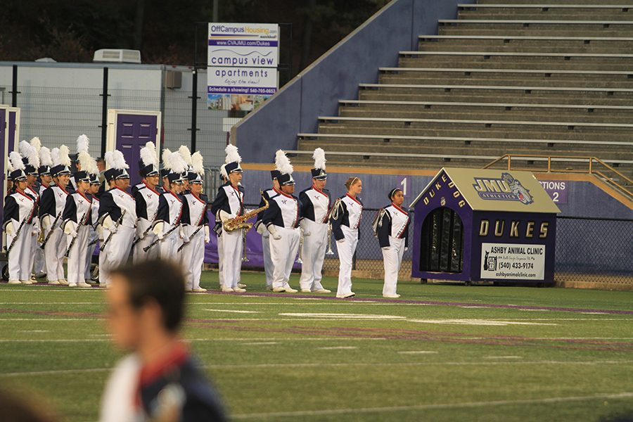 Juniors Emily Werner (Left) and Lizet Munoz (Right) lead the band onto the field. 