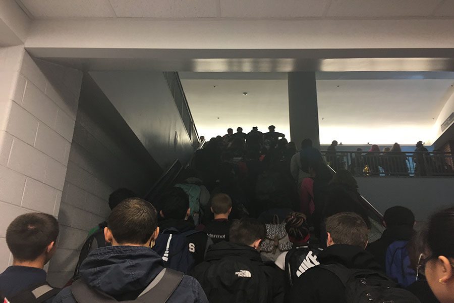 Students crowd the main stairwell on the way to class.