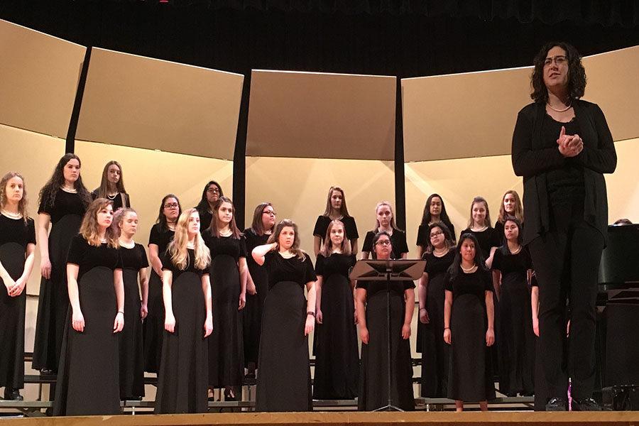 Bethany Houff introduces the combined Women’s Choir before the concert.