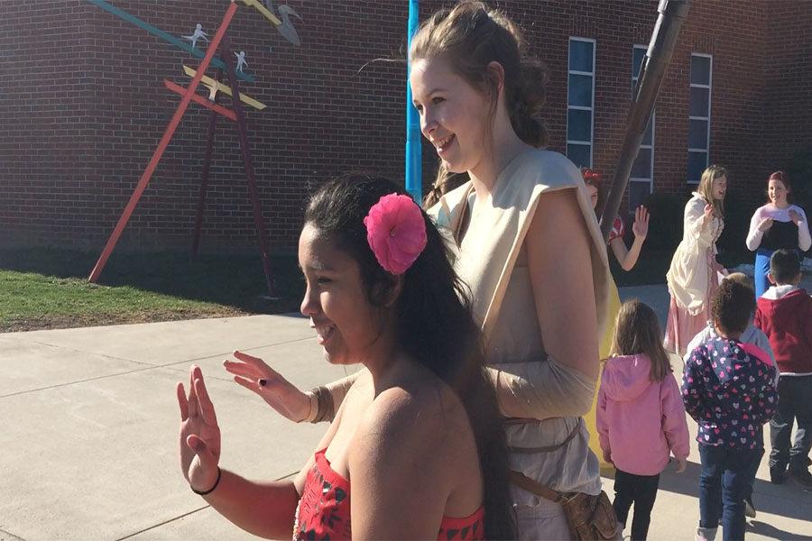Junior Lizet Muniz and Senior Cecily Lawton, dressed as Moana and Rey (from Star Wars the Force Awakens), greet the kids walking into the concert