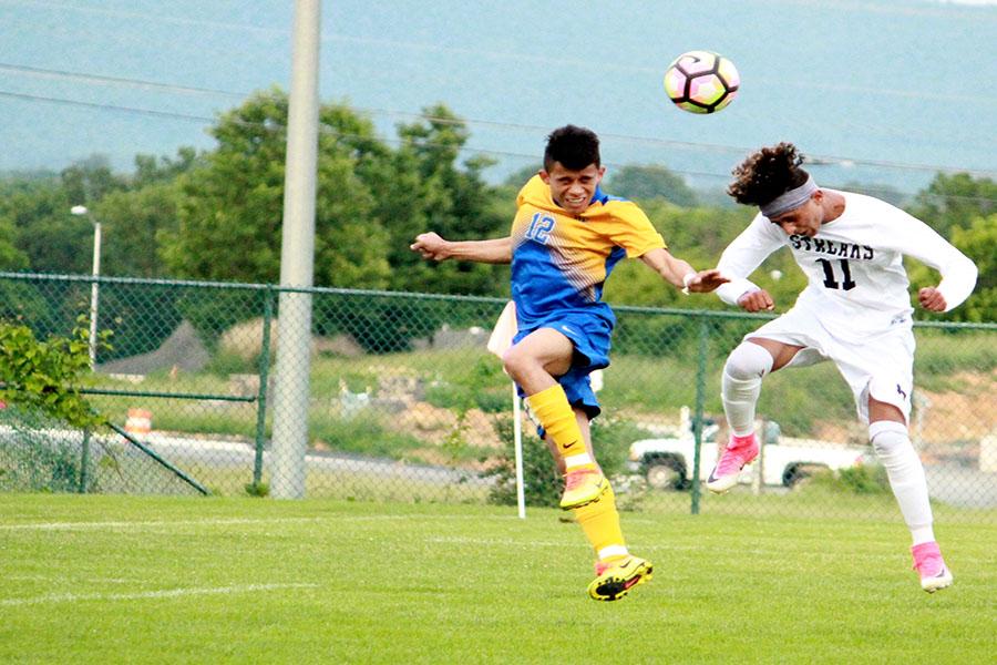 Imran heads the ball towards goal.