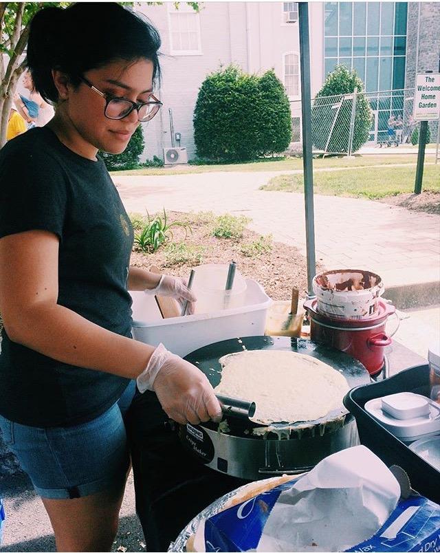 Freshman Rachel Hermosillo helps Eva Didot with her crepes on Saturday. 