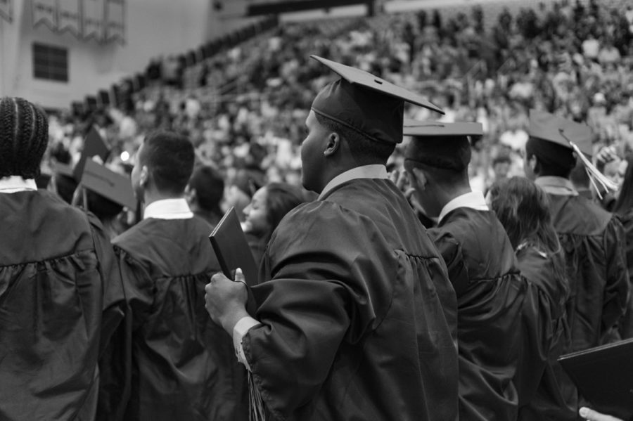 Students watch the graduation ceremony take place after receiving their diploma. 
