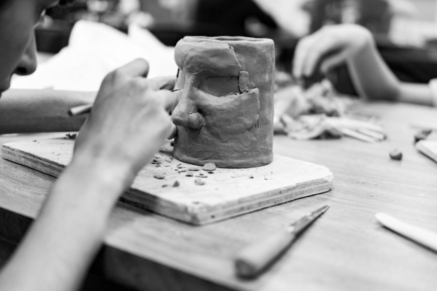 Walton captures a student crafting a piece of pottery.
