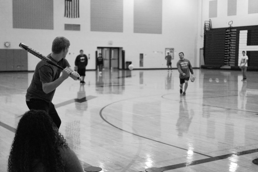 Students play a game of baseball in PE with Rath pitching the ball.