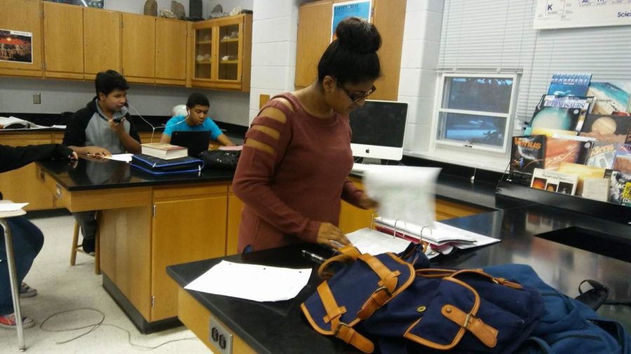 Freshman Lisbet Sanchez Garcia works happily at a standing desk in Earth Science Honers. 