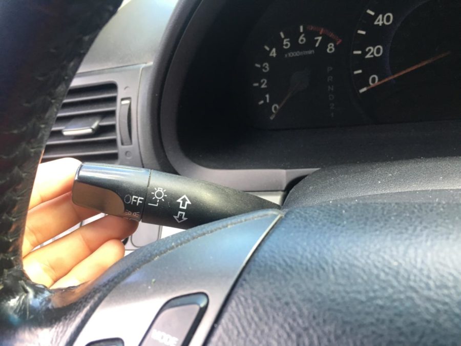 This is your turn signal lever. It is pushed up in order for your right signal to come on and down for your left.
