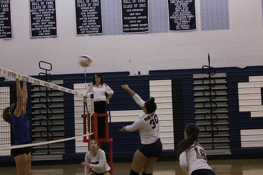 Sophomore Genesis Jimenez-Rivera hits the ball over to the other side.