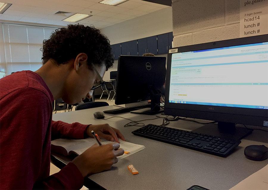 Senior Isaiah King doing his work in class. 