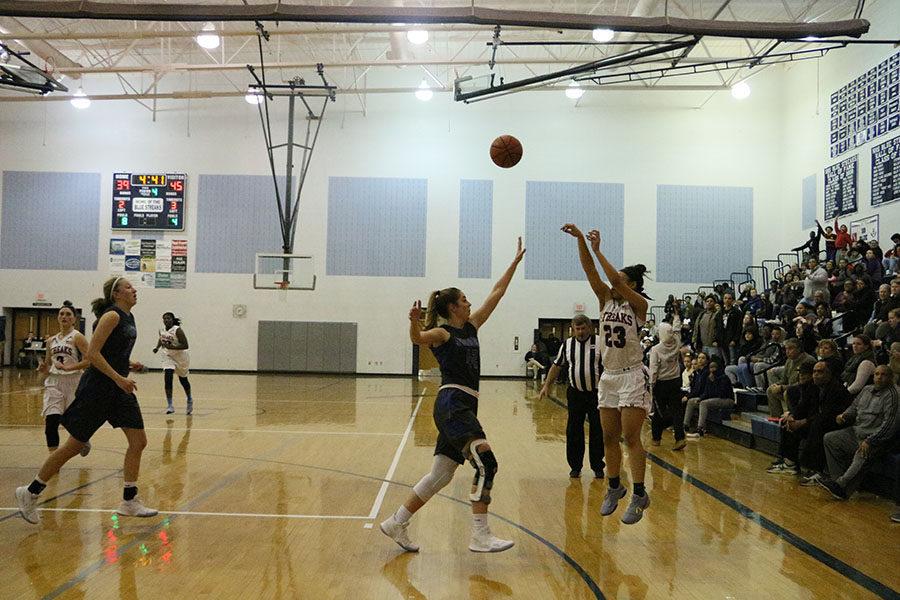 Sophomore Jakaya Brandon attempts to shoot a three-pointer in the last quarter of the game against Spotswood while the Streaks were down 45-39.