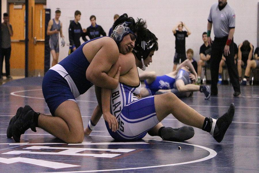 Fahad Mohammed holds back a Spotswood wrestlers arms to try to hold the win as the clock ran down in overtime.