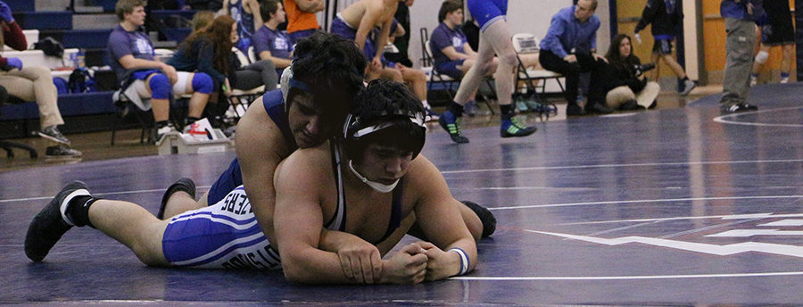 Fahad Mohammed lays on top of a Spotswood wrestler during the first period of their match.