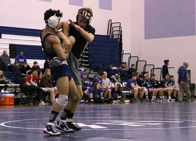 Guillermo Torres lifts Payton Jackson. Torres won the match to remain undefeated with a record of 28-0.