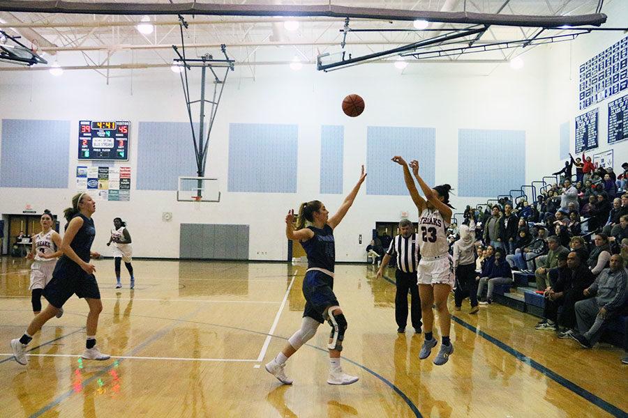 Sophomore Jakaya Brandon attempts a three-pointer over a Spotswood defender in the final quarter.