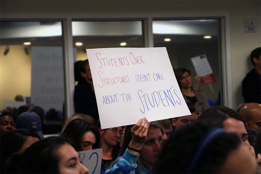 Senior+Marley+Adamek+holds+up+a+sign+at+the+city+council+meeting+Jan.+23.+Students+were+among+those+in+the+audience+when+the+council+voted+to+build+in+2023.