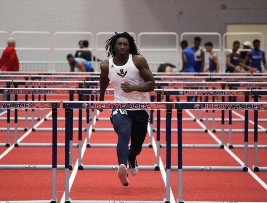 Sophomore Jaylin Smith approaches the final hurdle in the mens 55 meter hurdles. Smith set a personal record with a time of 9.86.