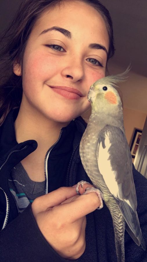 Malashiy poses with her bird, Jojo