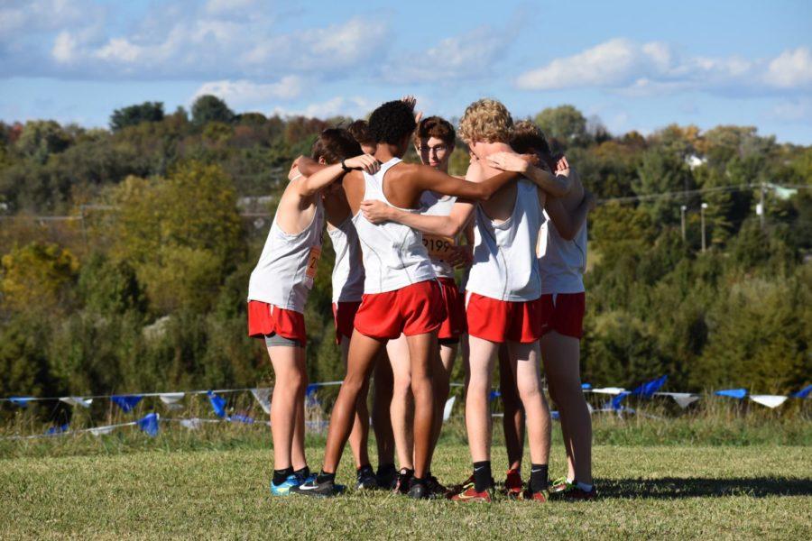 The cross country team huddles up before their district meet race