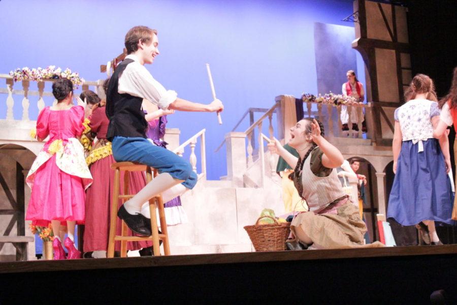 Senior Nick Burzamato and sophomore Grace Miller perform as village people in the first village scene of the musical.