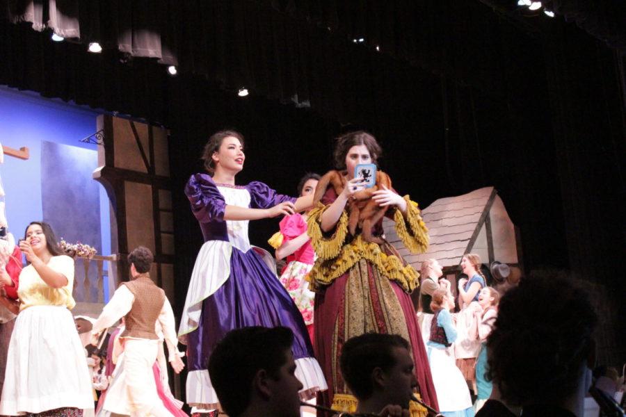 Senior Gabby Wilson and junior Julia Inouye react to their invitation to the prince's ball in the First Act, as the stepmother and one of the stepsisters of Cinderella.