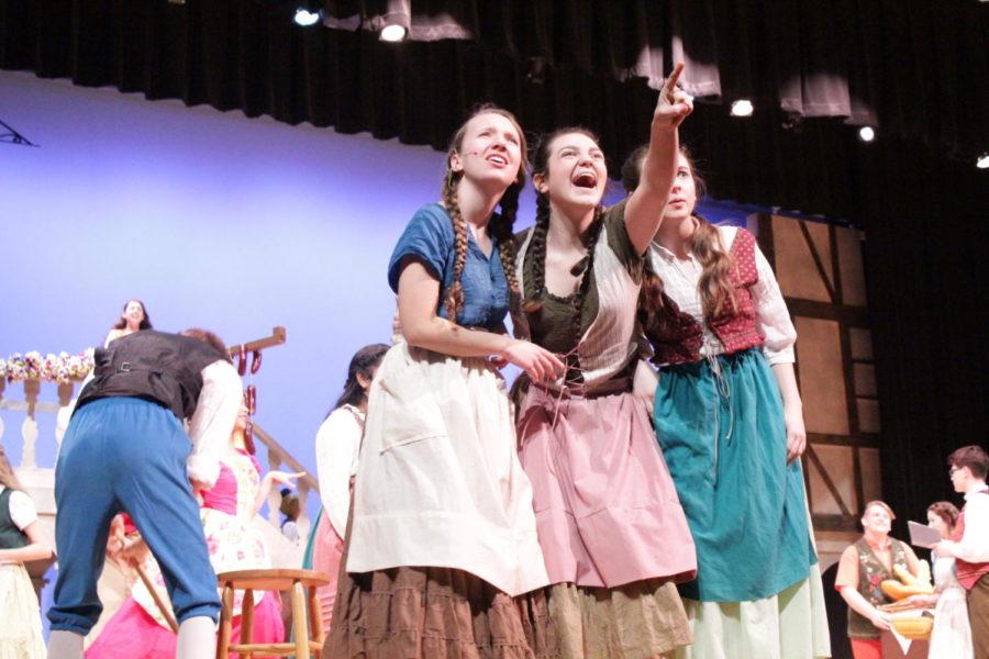 Sophomores Carly Corso, Grace Miller and freshman Cecilia Thomas, in the ensemble, react to the audience during the first scene.