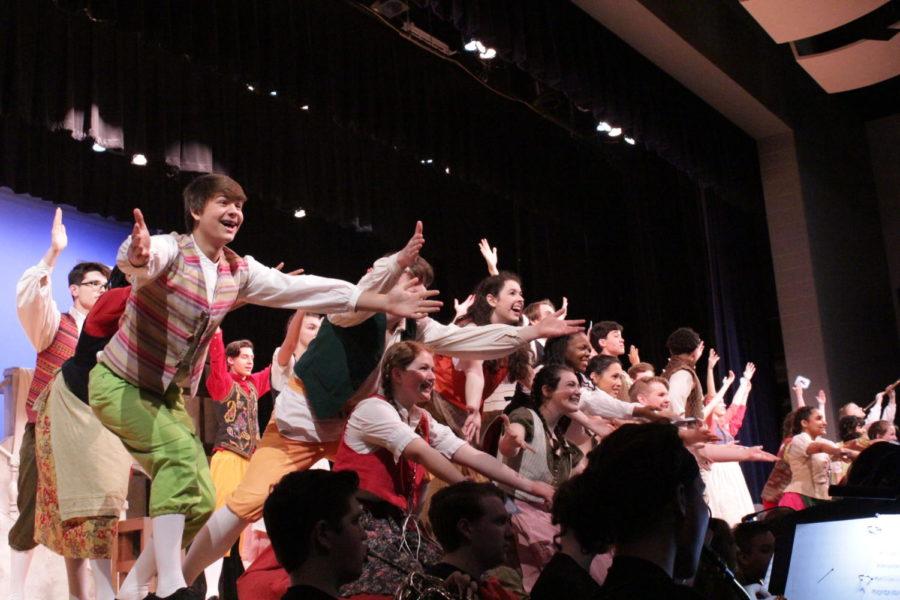 The ensemble finishes the first number of the show, "The Prince Is Giving a Ball".
