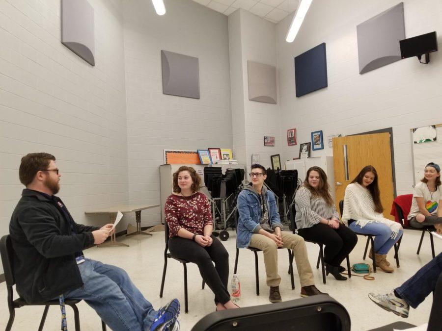 (Left to right) Physics teacher and head of GSA Seth Berkeley leads sophomore Faith Evans-Haywood, senior Derek Shifflett, freshmen Jordyn McHone and Genesis Marshall and junior Heather Whetzel in a discussion about pizza to shake out any nerves. 