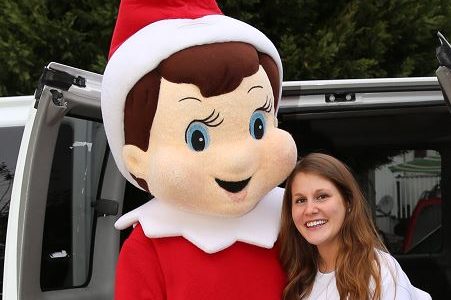 Sharrer poses with a life-size Elf on the Shelf doll.