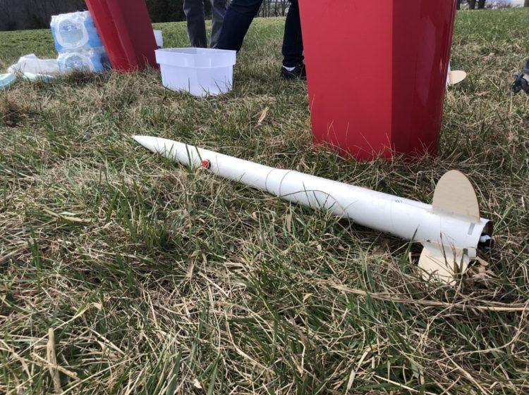 A group of students finish their rocket and wait for others to finish. 