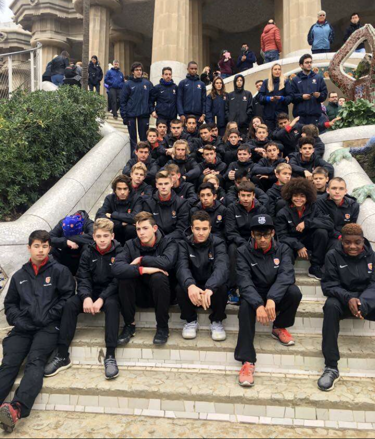 Bianchi and 40 other selected players from all over the United States sit on the steps of a tourist attraction in Barcelona.