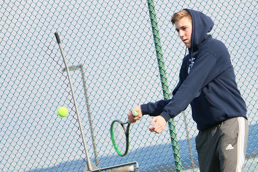 Sophomore Gabe Eshleman hits forehand groundstrokes from the baseline.