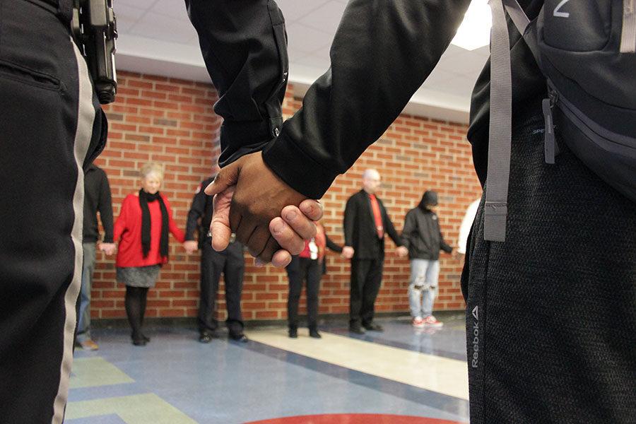 Members of the community join hands in recognition of the shooting at Stoneman Douglas High School. HHS spent 17 minutes holding hands in a unity chain around the halls to show their support.