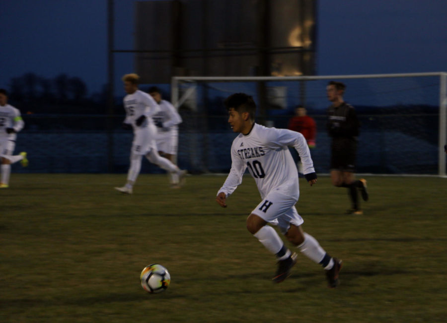 Junior Eric Ramirez rapidly takes the ball up the field.