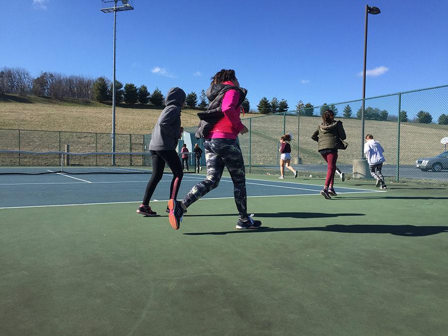 The tennis team warms up for practice. 