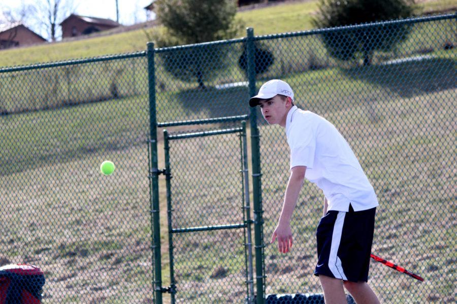 Junior John Collier returns the ball in his doubles team with Junior Tobias Yoder.