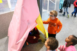 Kindergarteners examine one of the prototypes at the showing.