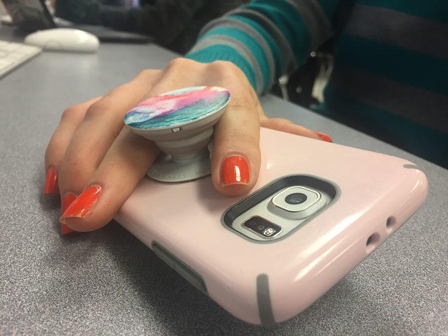 A+student+holds+their+phone+during+class.