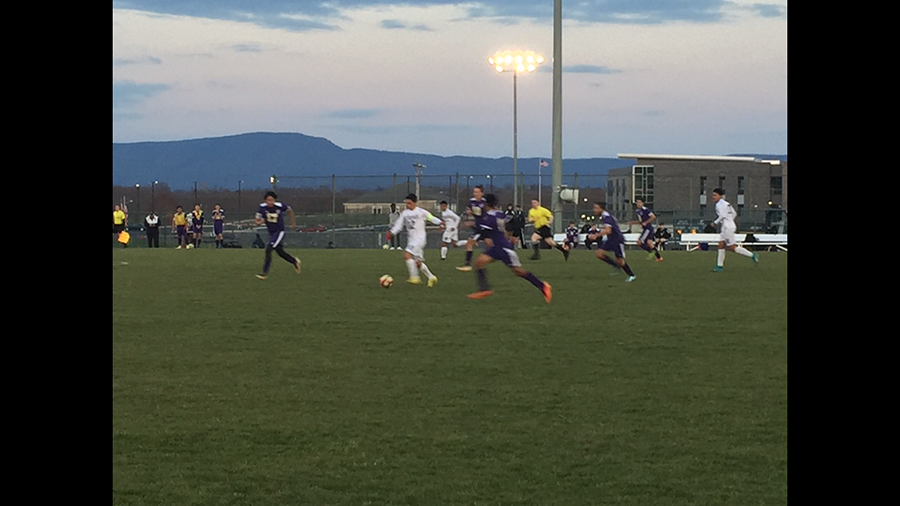 Wayesboro varsity soccer team follows the ball.