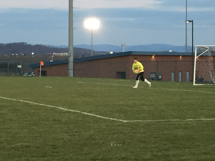 The goalie gets the ball.