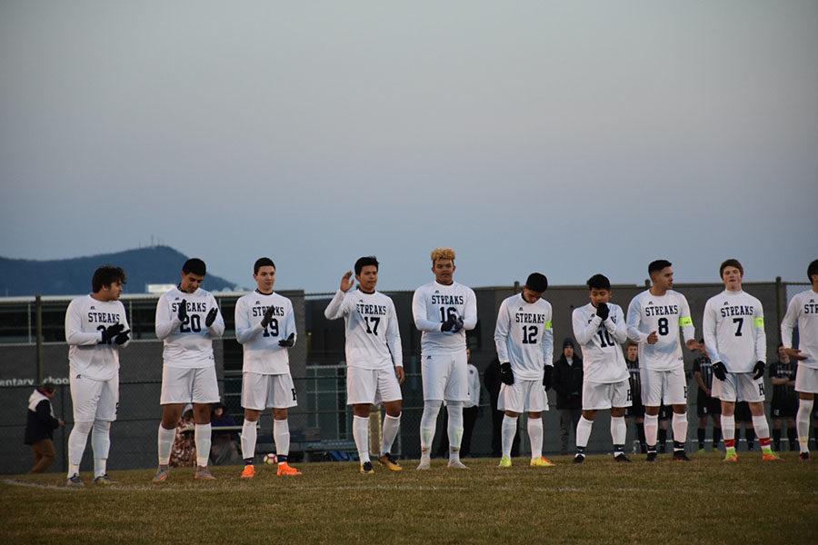 The varsity soccer team lines up to get their names announced at a home game last year.