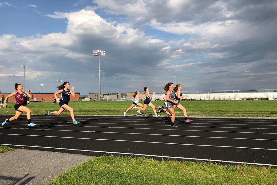Seniors Carissa Roberts and Sydney Harper and freshman Elena Luhn run the 100 meter dash. Roberts reflects on what made her last season great. It was definitely the friends. I’ve also gotten some great tan lines, so that’s amazing. I love my relays and I love running well, Roberts said. 
