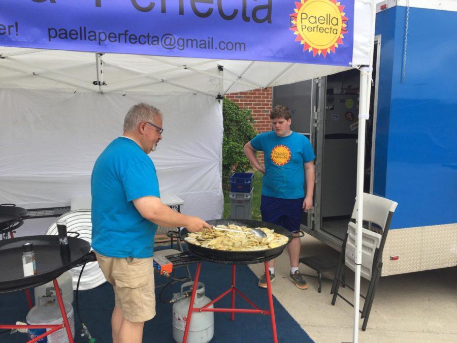 The McIntires serve paella during the event. 