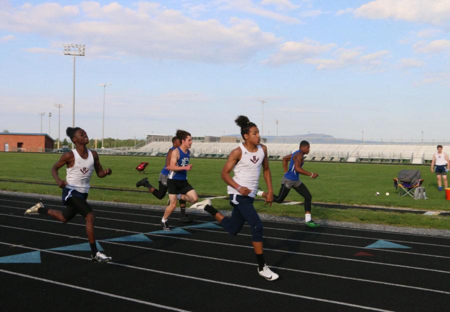 Freshman Isaiah Hamilton crosses the finish line of the boys 100 meter. 