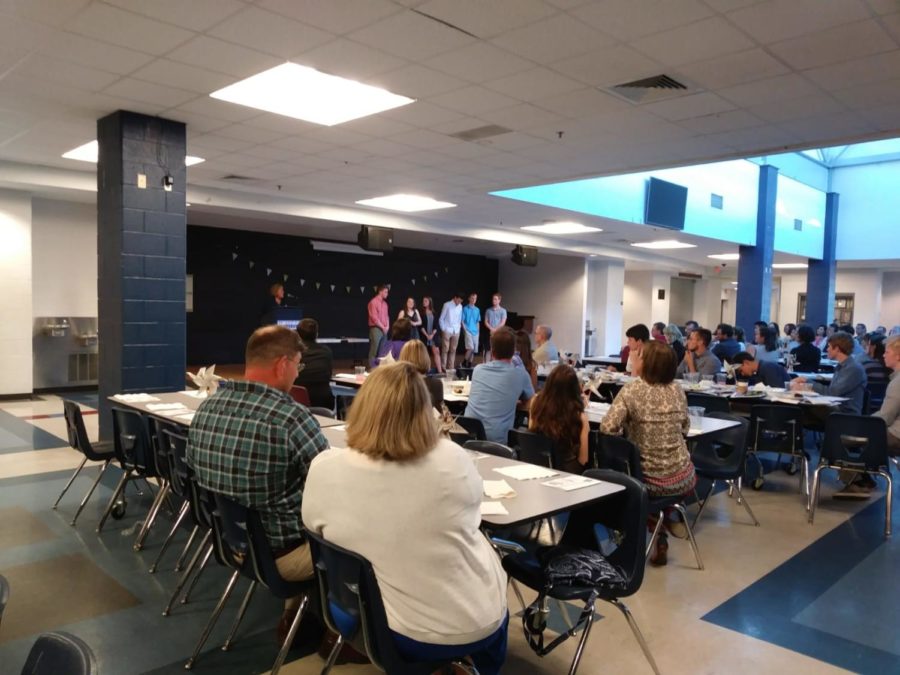 HHS newstreak students and parents are listening to English teacher Valerie Kibler giving out awards 