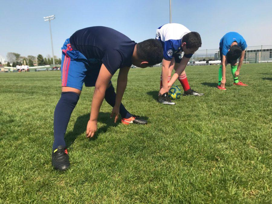 Skyline middle school students stretch during warm ups. 
