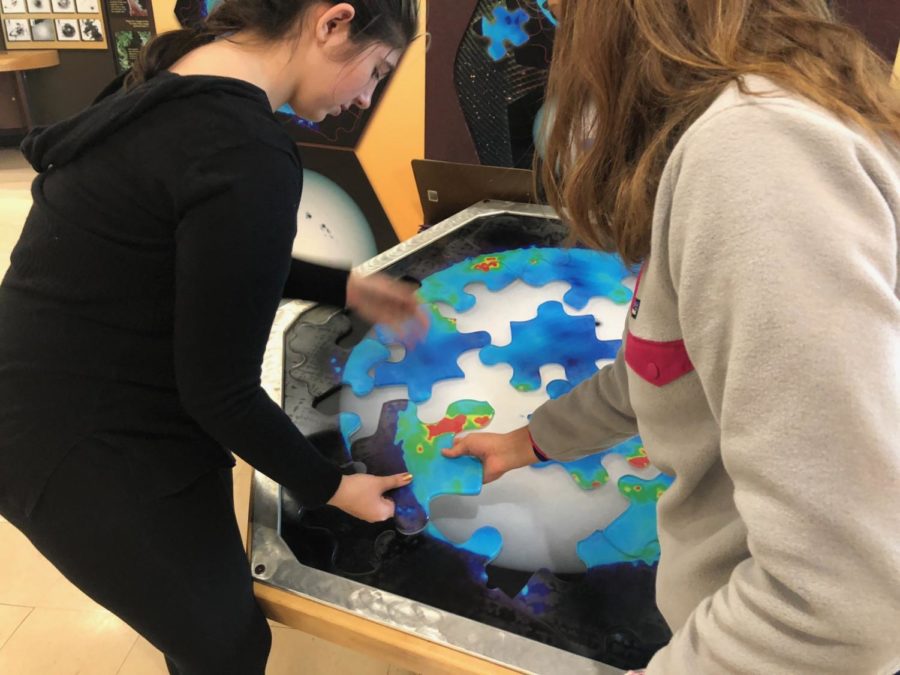 Sophomores Arianna Casterline and Mia Constantin solve a puzzle showing the difference between an optical and infrared view of the sun.