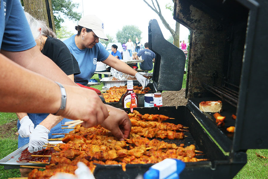 Puerto Ricans at the Pinchos booth are hard at work cooking and selling Pinchos.
