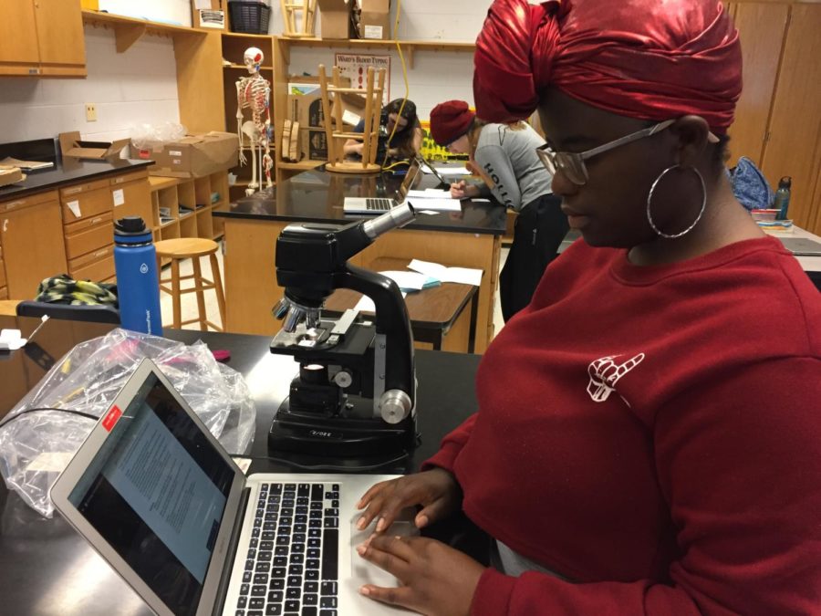 Senior Glorious Njoroge works on a lab.