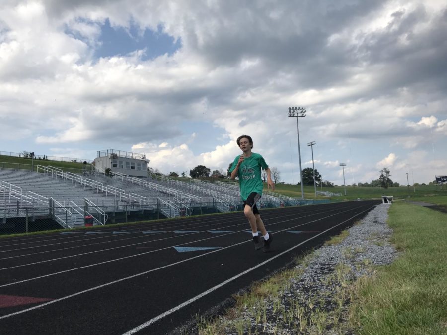 Freshman Evan Newfeld gets ready for competition by running during practice. 