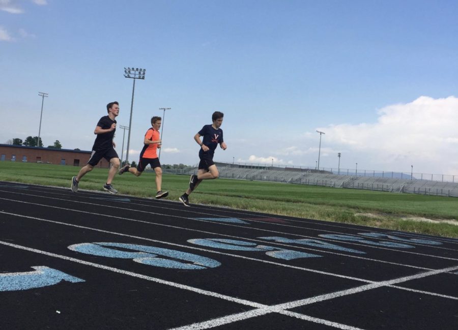 Sophomore Haiden Kirwan runs a quarter of a mile with two of his teammates.